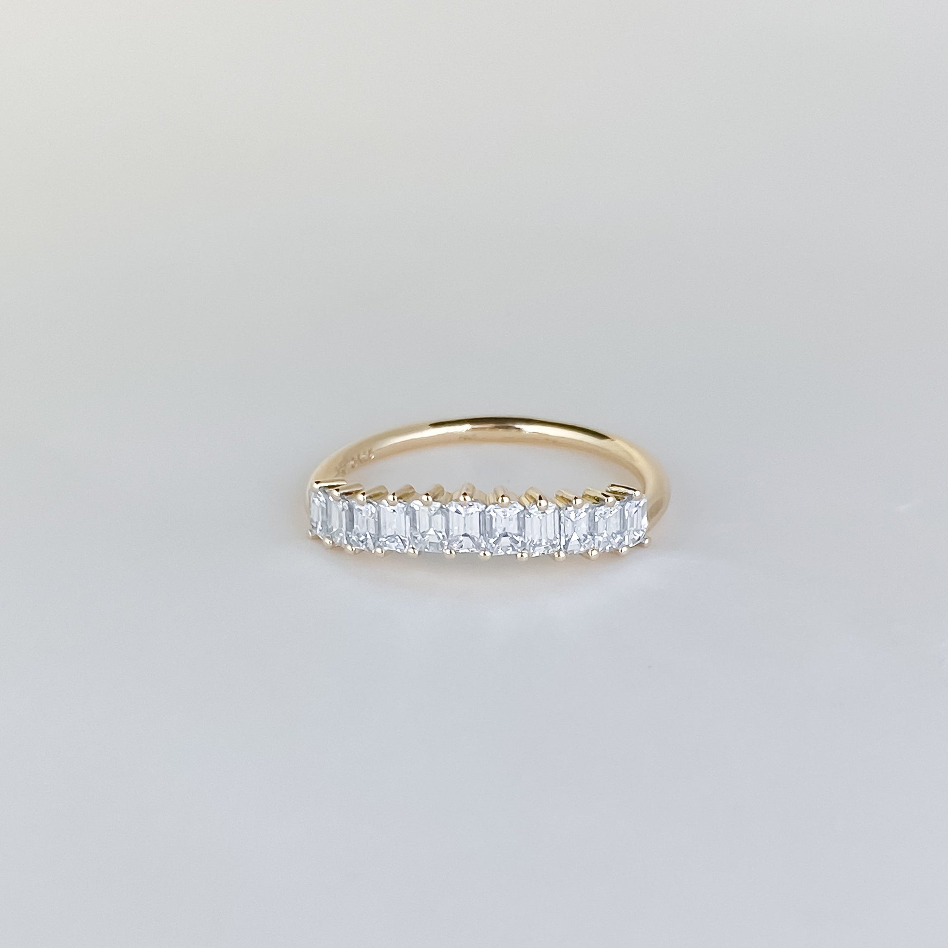 0.68 TCW Emerald Curved Moissanite Wedding Band